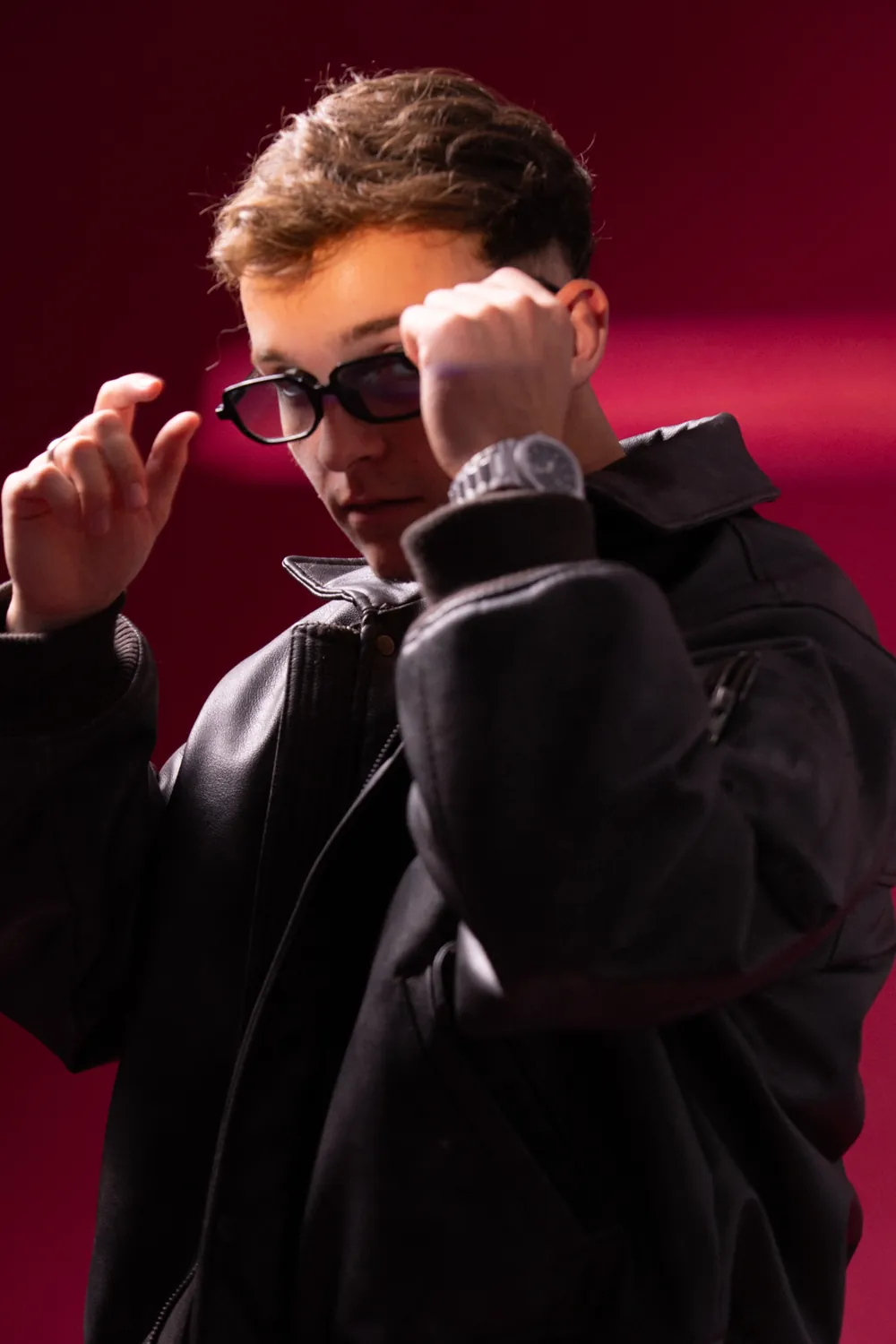 Kotto adjusting his glasses